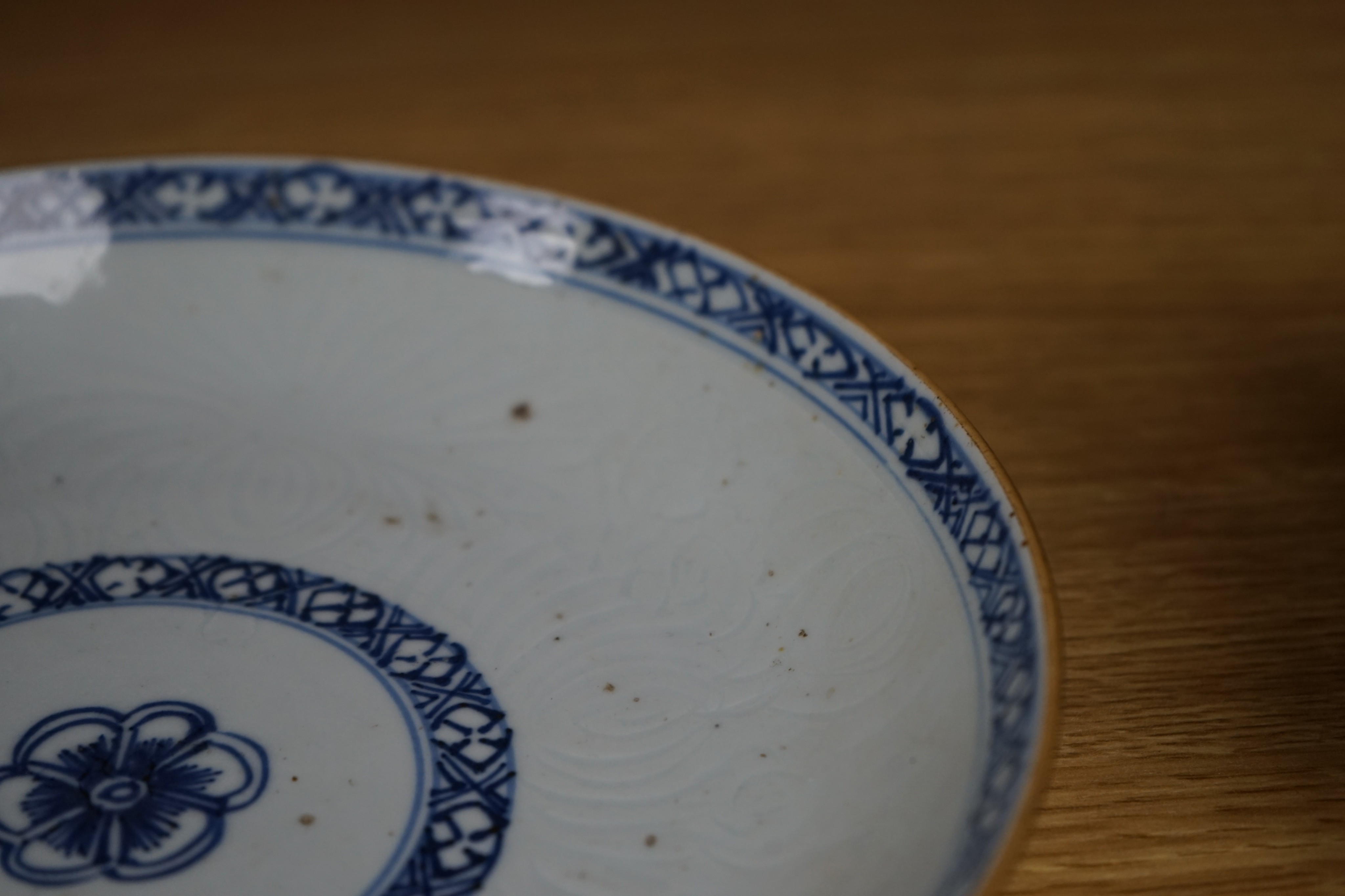 An 18th century Chinese shallow circular blue and white dish with incised decoration, Dia 22cm